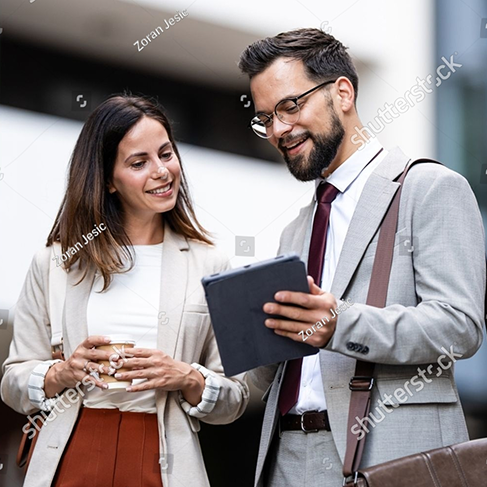 Stock Photo Businessman And Businesswoman Reviewing A Project On A Digital Tablet During A Coffee Break In The 2670213461 1